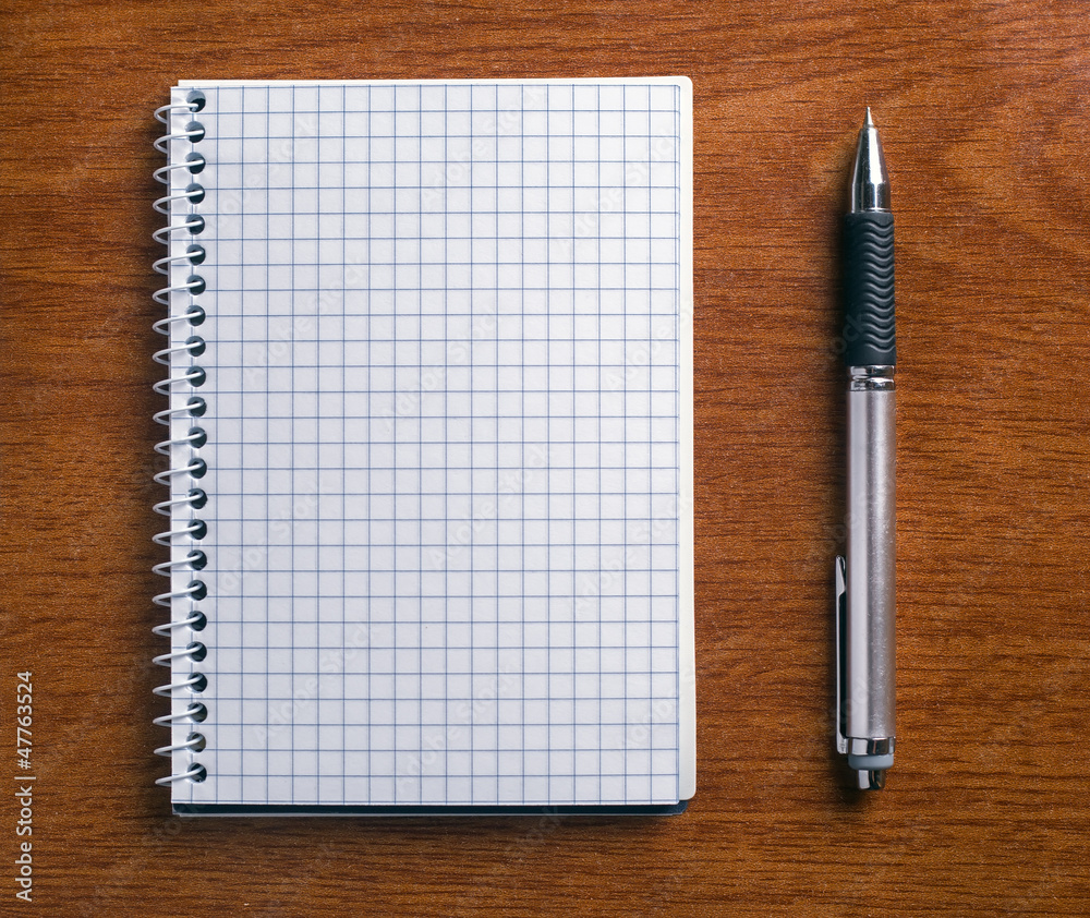 Pen and notebook on a wooden table. Pen and notebook on a wooden table.