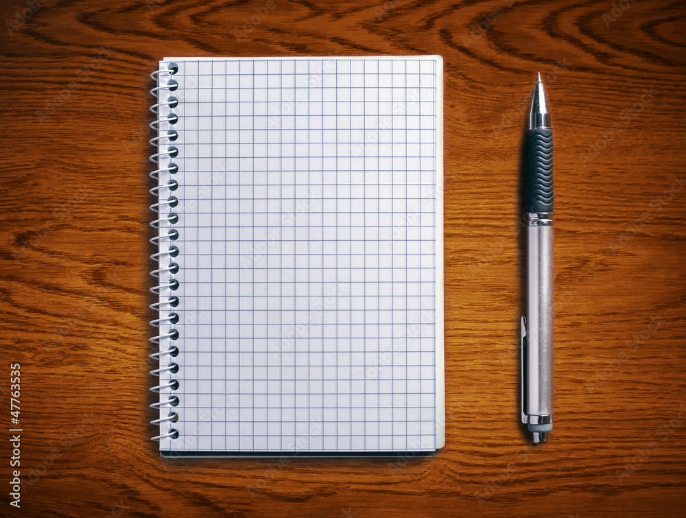Pen and notebook on a wooden table. Pen and notebook on a wooden table.