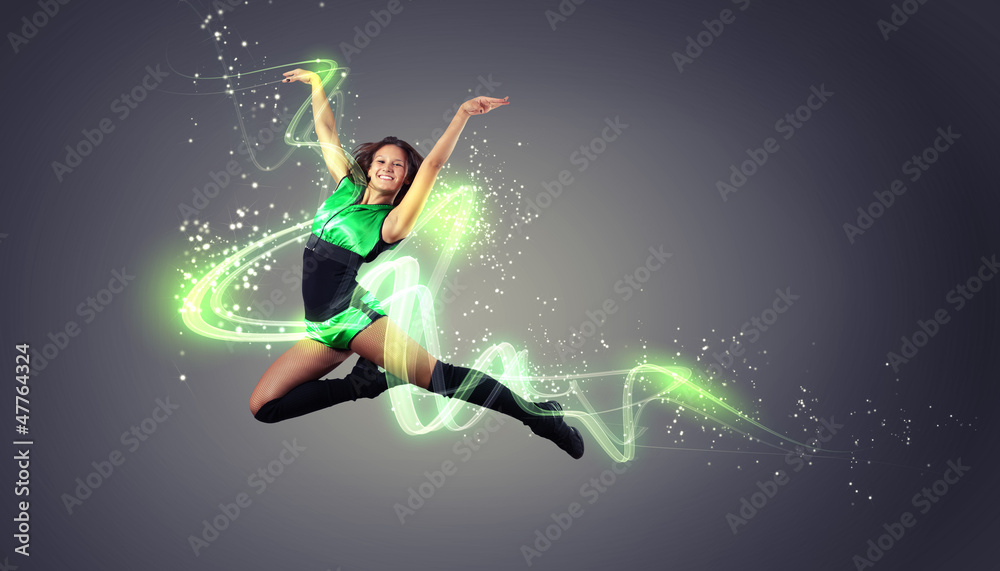 Young woman dancer. With lights effect.