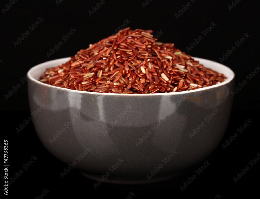 Red rice in gray bowl isolated on black Red rice in gray bowl isolated on black