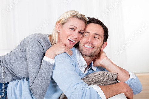 Happy man and woman cuddling