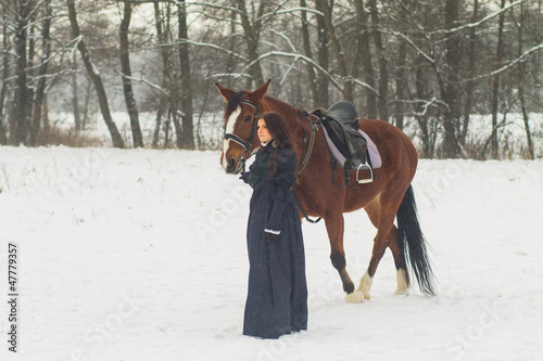 Beautiful woman and horse in winter