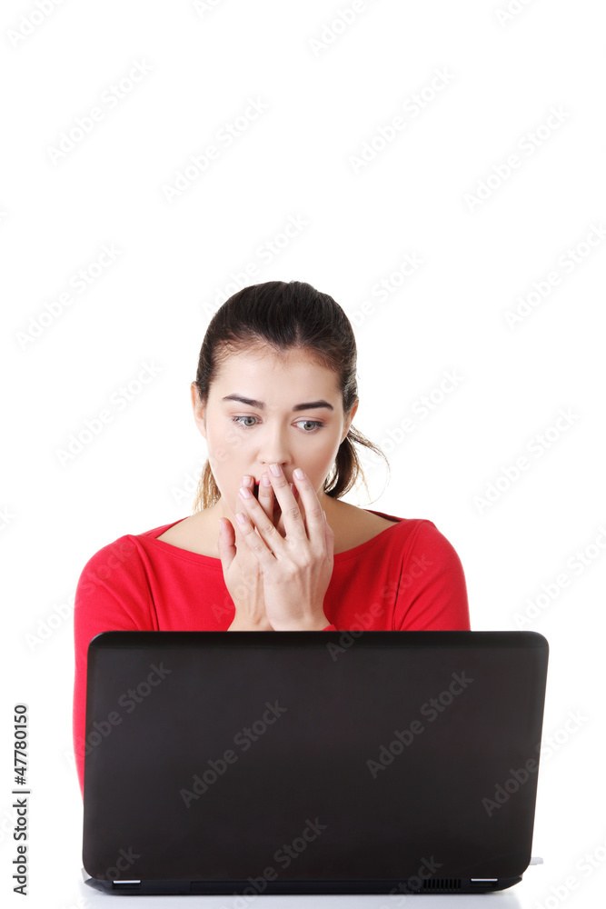 Surprised and disgusted woman working on laptop. Surprised and disgusted woman working on laptop.