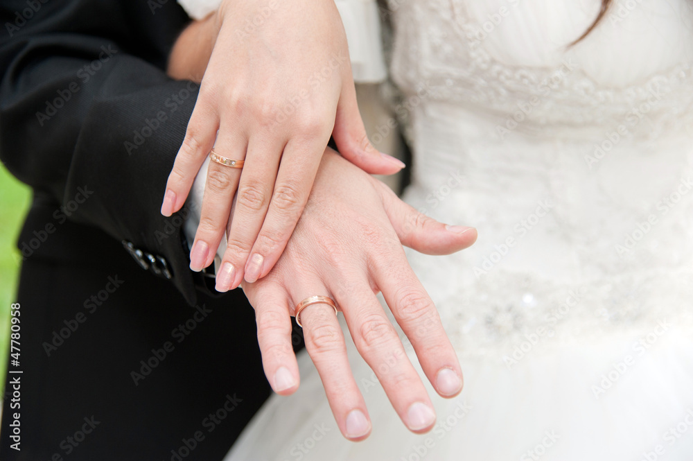Loving couple holding hands with rings Loving couple holding hands with rings
