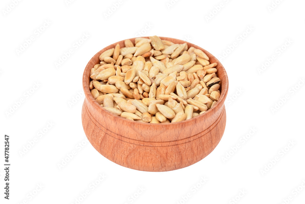 Sunflower seeds in wooden bowl, isolated on white background Sunflower seeds in wooden bowl, isolated on white background