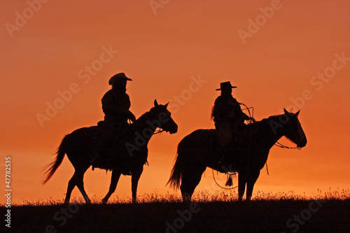 Cowboys on Horseback Silhouette at sunset