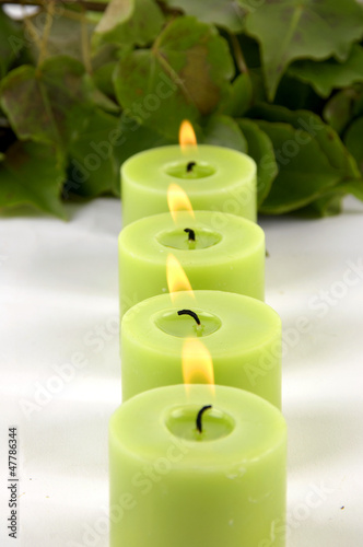 relaxing treatment    row of green candle with leaf