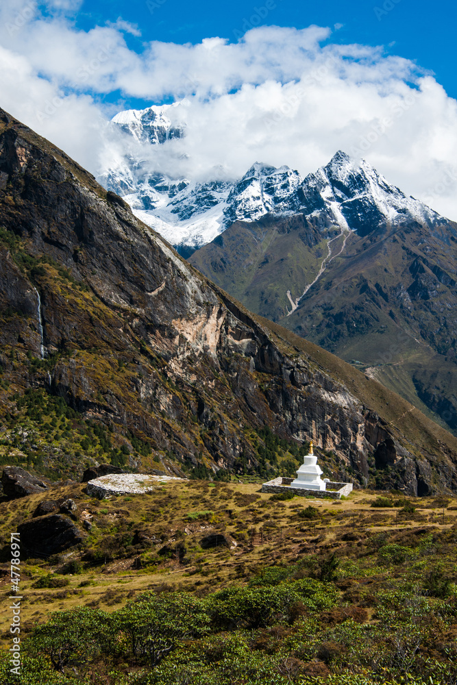 Buddhist stupe or chorten and summits in Himalayas