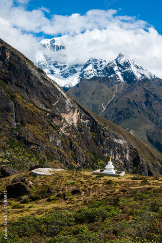 Buddhist stupe or chorten and summits in Himalayas