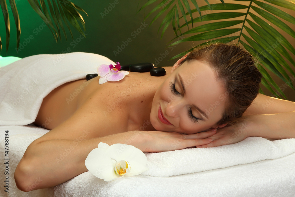 beautiful young woman in spa salon with spa stones, beautiful young woman in spa salon with spa stones,