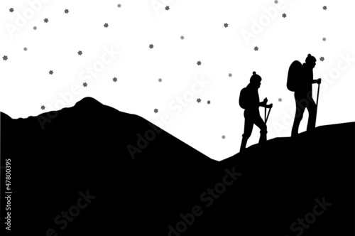 Mountain climbing in winter, hiking couple with rucksacks