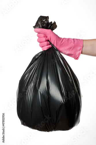 Hand holding trash bag