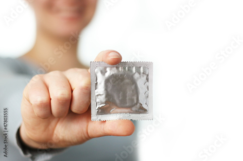 woman holding a condom