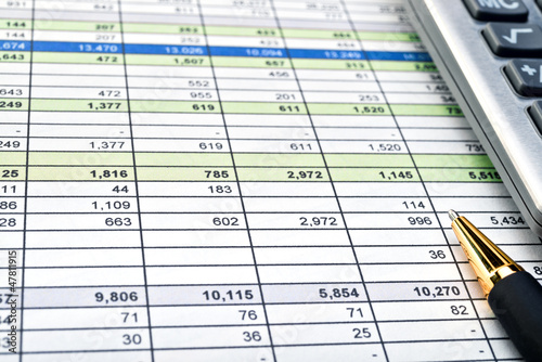 Financial forms with pen and calculator.