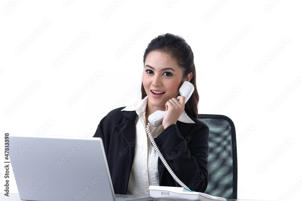 woman working on laptop and talking on the phone woman working on laptop and talking on the phone