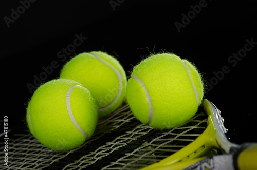 Tennis balls and racket