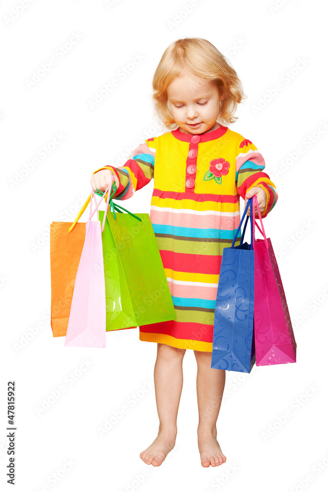 Bright happy kid with shopping bags in hand. Bright happy kid with shopping bags in hand.