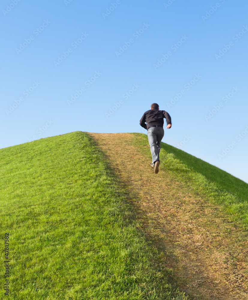 Pathway up the hill against the sky. Man ran to the top