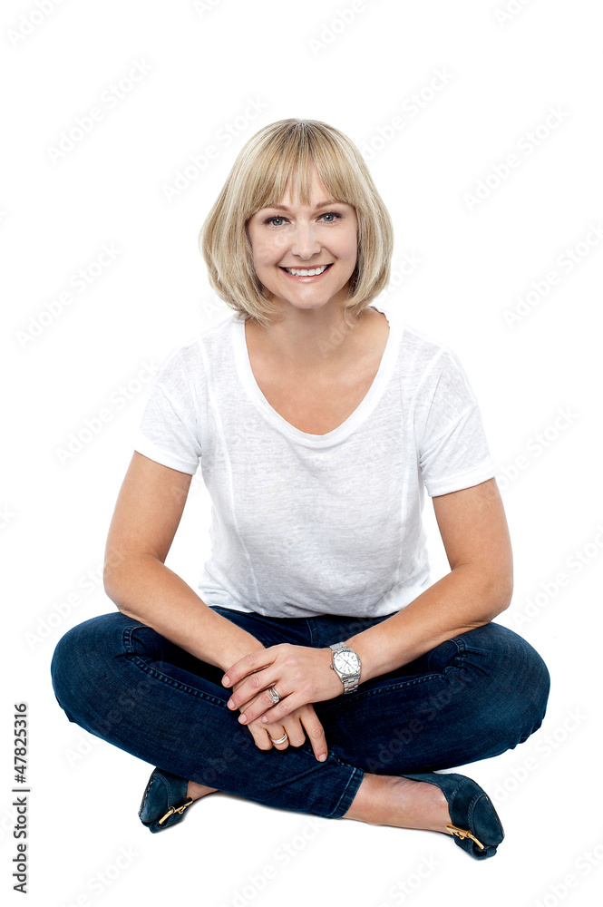 Smiling middle aged woman sitting on the floor Smiling middle aged woman sitting on the floor