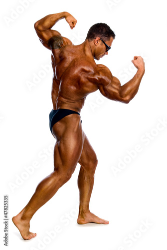 Attractive male body builder, demonstrating contest pose