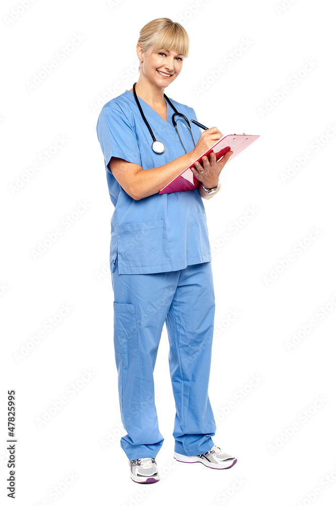 Smiling nurse preparing case sheet of a patient