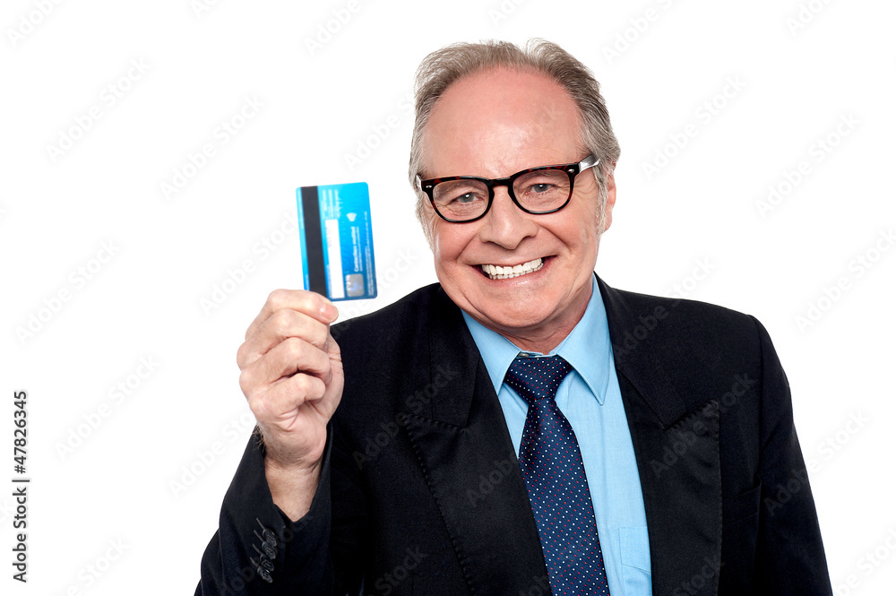 Old man wearing eyeglasses holding up a cash card Old man wearing eyeglasses holding up a cash card