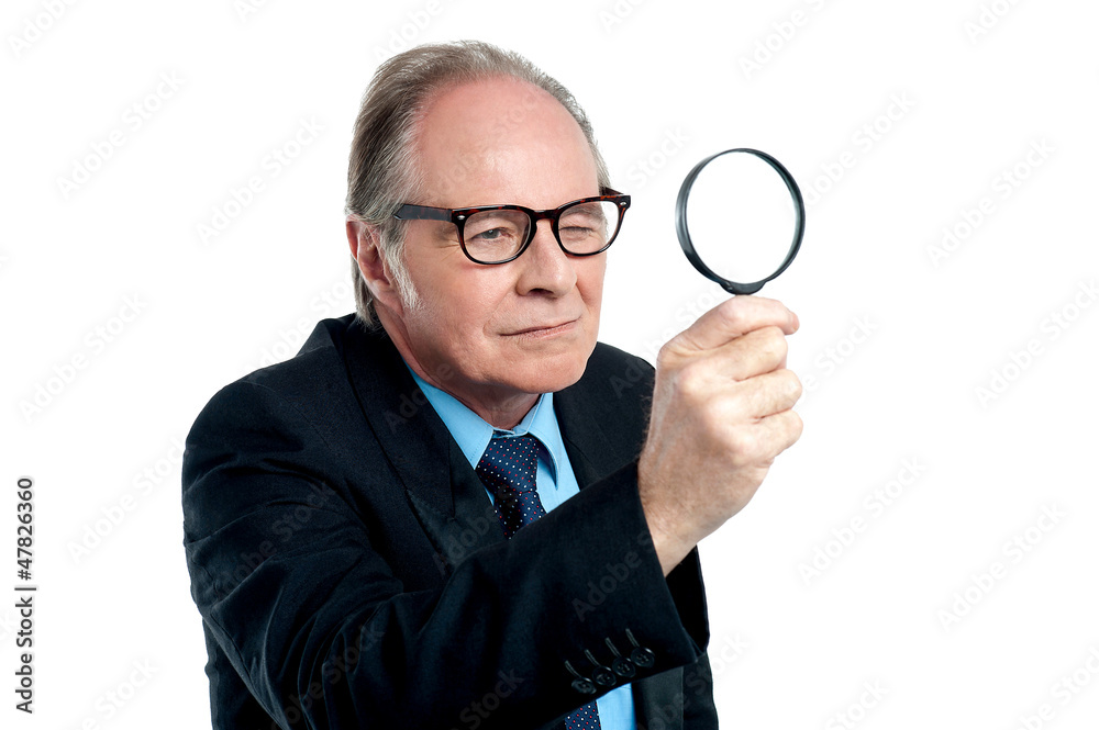 Detective exploring through a magnifying glass Detective exploring through a magnifying glass
