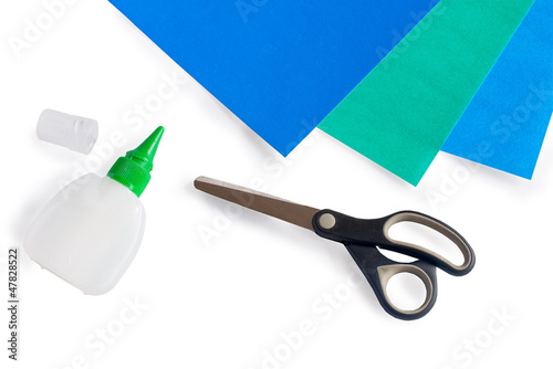 Scissors, glue and paper on a white background