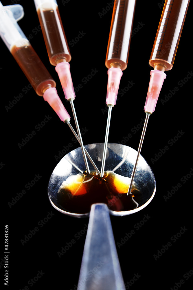 Cooked heroin and a group of drug syringes Cooked heroin and a group of drug syringes