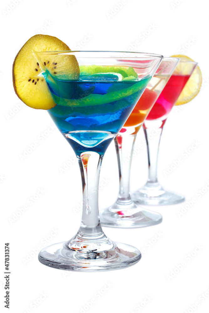 Three colorful drinks in cocktail glasses, isolated