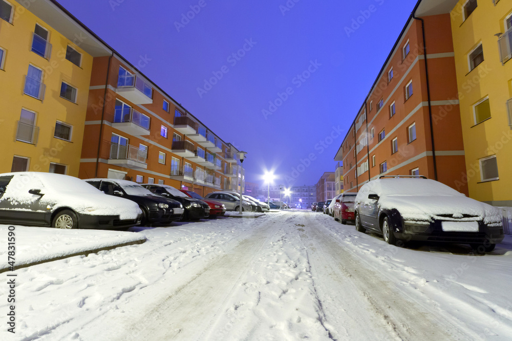 Snowy street with cars at winter in Poland