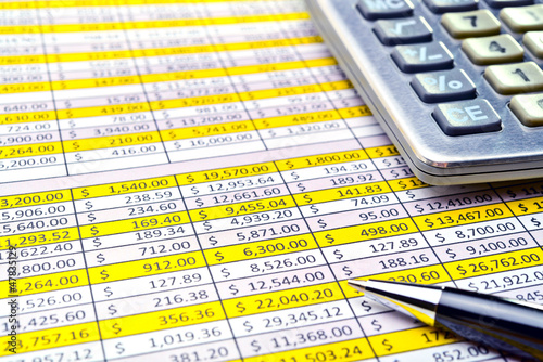 Financial forms with pen and calculator.