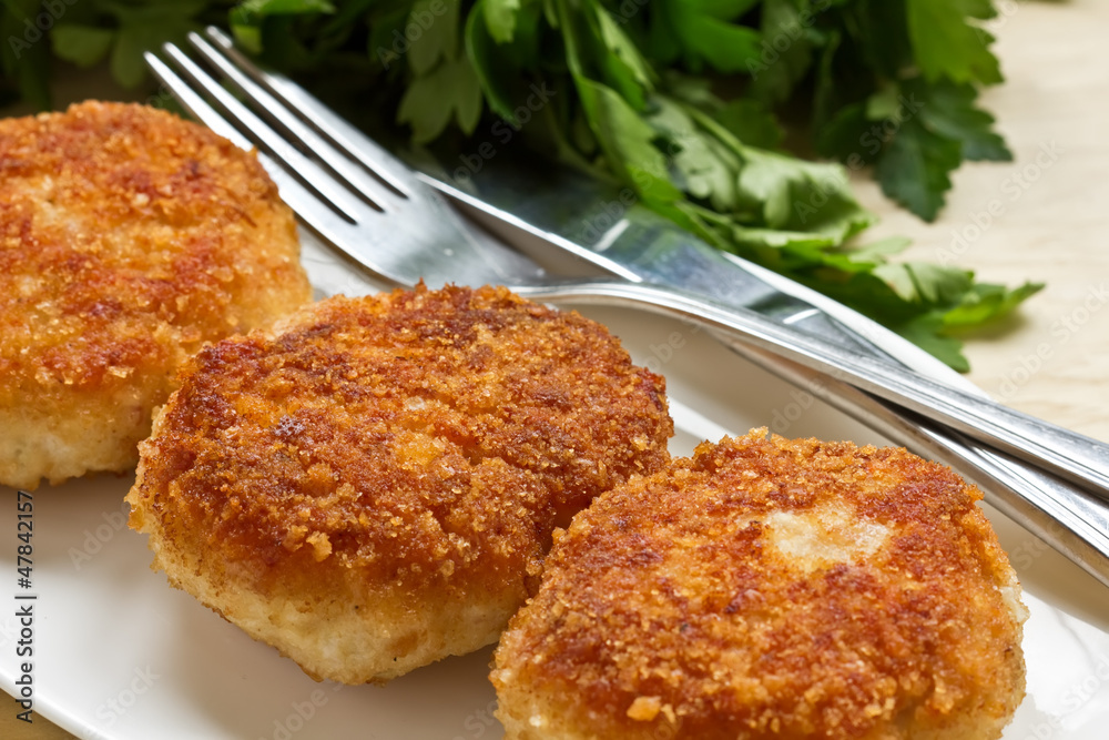 Chicken cutlets on white plate
