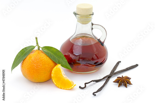 Bottle of liquor with mandarin, anise & vanilla pod