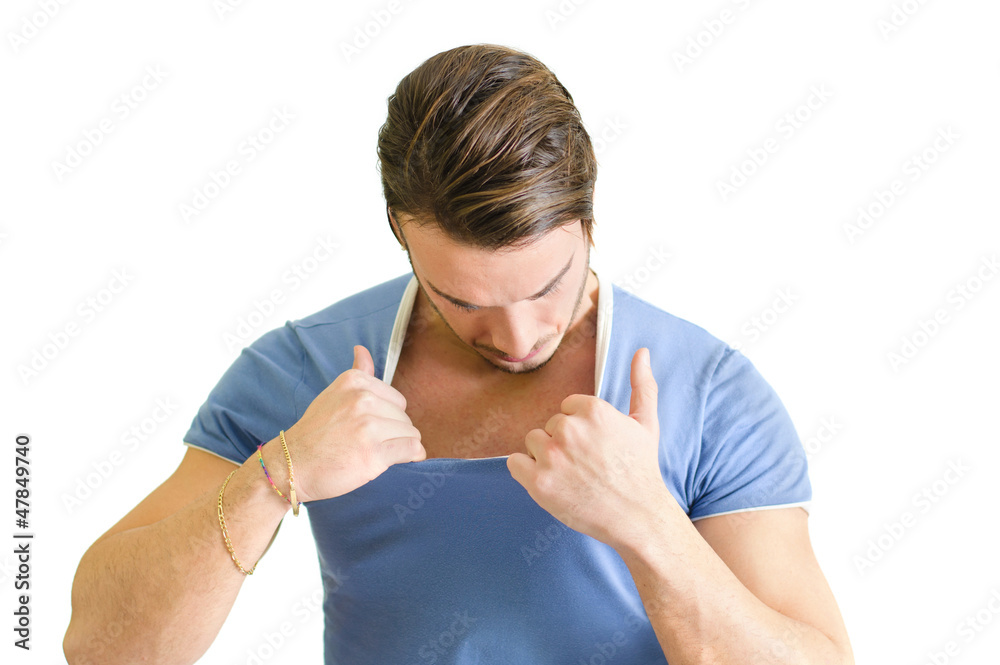 Muscular guy checking out his chest muscles Muscular guy checking out his chest muscles