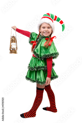 Girl in suit of Christmas elf with oil lamp