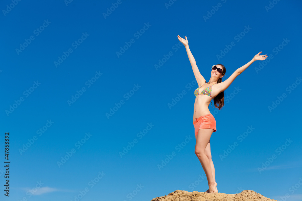 Portrait of young woman in bikini at beach