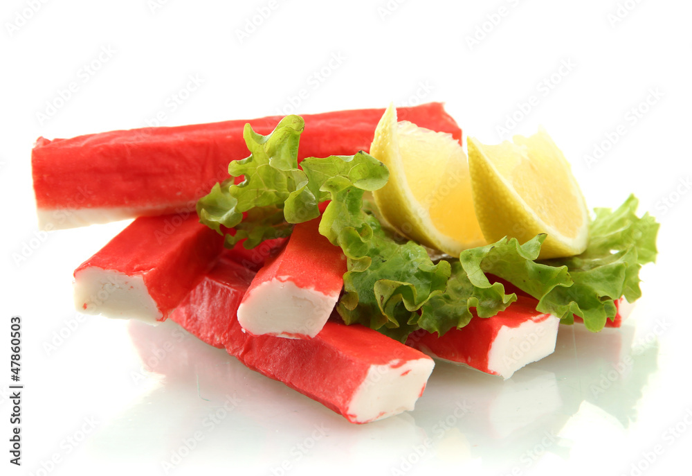 Crab sticks on lettuce leaves with lemon, isolated on white Crab sticks on lettuce leaves with lemon, isolated on white