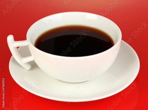 A cup of strong coffee on red background
