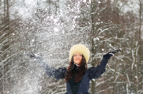 young woman playing with snow