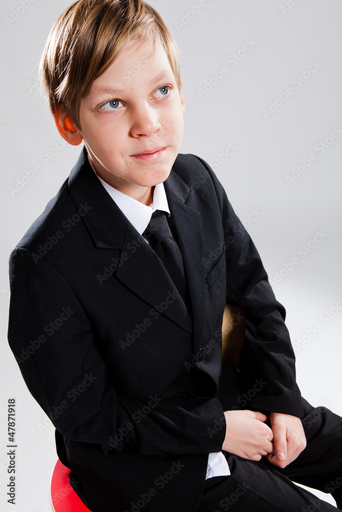 Smiling young boy wearing black suit Smiling young boy wearing black suit