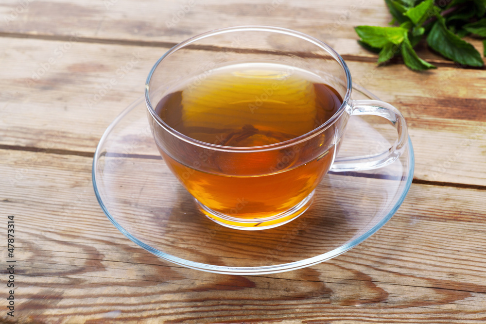 Cup with green tea and fresh herbs Cup with green tea and fresh herbs