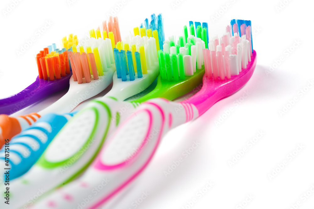 set of multicolored toothbrushes isolated on white set of multicolored toothbrushes isolated on white