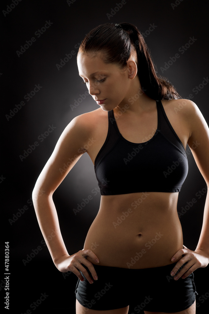 Young fit woman sport posing on black Young fit woman sport posing on black