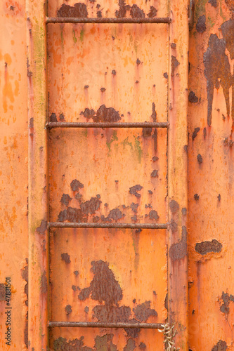 steps of old orange and rusty container on vertical image © ahavelaar