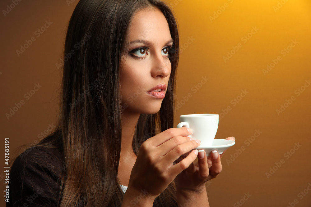 beautiful young woman with cup of coffee, on yellow background beautiful young woman with cup of coffee, on yellow background