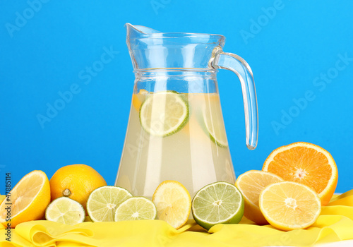 Citrus lemonade in glass pitcher of citrus around