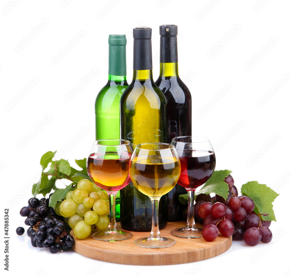 bottles and glasses of wine and assortment of grapes, isolated