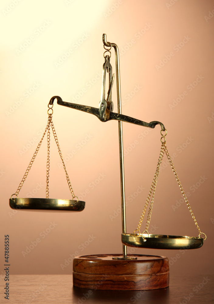 Gold scales of justice on brown background Gold scales of justice on brown background
