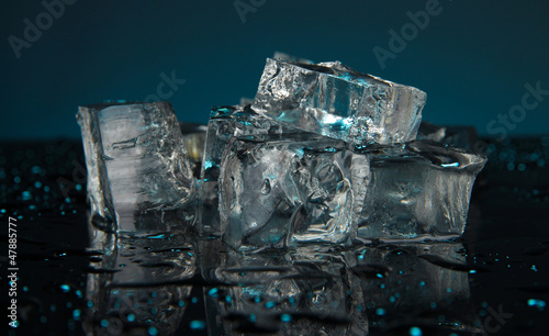 Ice cubes on dark blue background